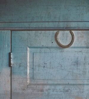 An iron horseshoe hung above a doorway, a traditional protection against malevolent Fae.