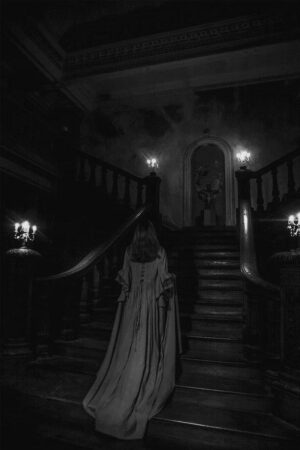 Woman walking down stone steps into shadow, symbolizing the descent of mystery school initiation